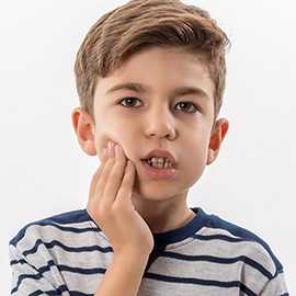 Boy in pain holding jaw