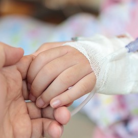 IV needle in child’s hand