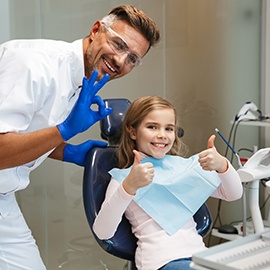 Happy girl posing for photo with her dentist