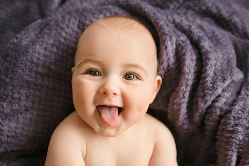 a baby sticking its tongue out