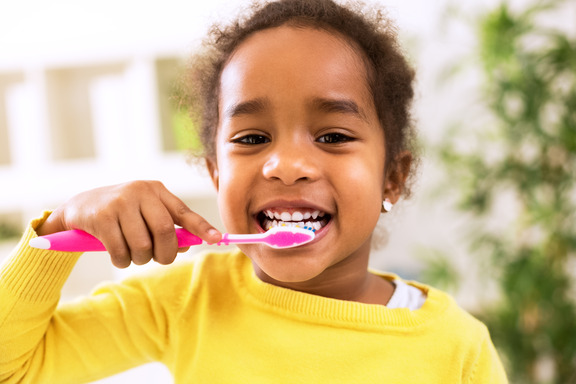 closeup of young girl brushing teeth 